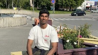 En ung mann foran en benk