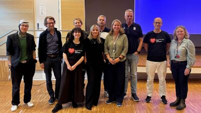 På bildet står en gruppe mennesker i en gymsal, det er de som har vært involvert i prosjektet, dette er navnene fra venstre til høyre:  Zeynab Bouhedjeur fra Minotenk, Peder Nustad fra Dembra, Amanda Anvar fra Stopp Hatprat, Cecilie Stokke fra Politiet, Trine Andersen fra Grefsen skole, Alf Bakkland fra Salto, Henriette Randsborg fra Kjelsås og Maridalen skoler, Truls Nygaard fra Kjelsås IL, Eirik Rise fra Stopp Hatprat og Birgitte Stub fra Disen skole.