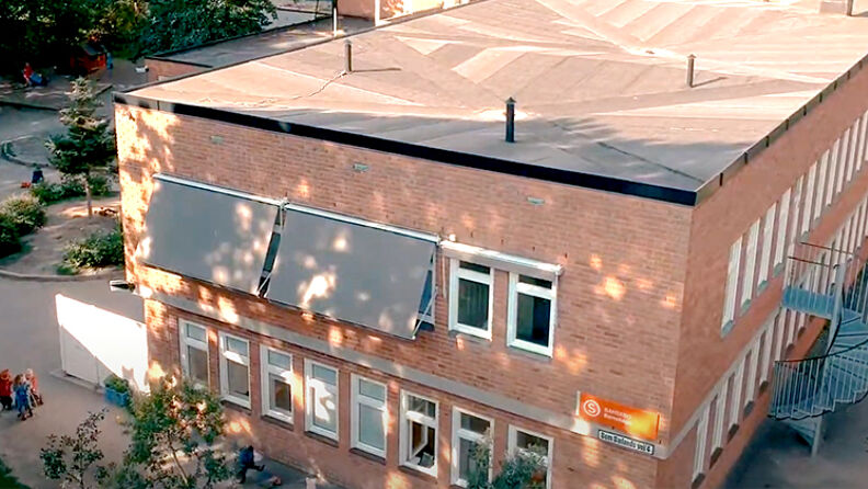 Barnehagebygningen og deler av lekeplasssen sett ovenfra