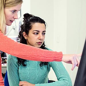 Two women looking at a computer for job information