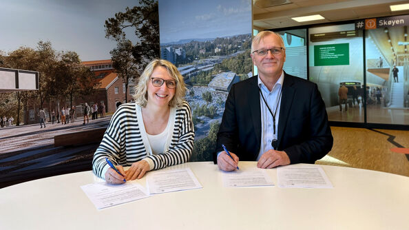 Irene Måsøval, etatsdirektør i Fornebubanen og Arild Moe, administrerende direktør i NRC Group Norge, signerer kontrakten.