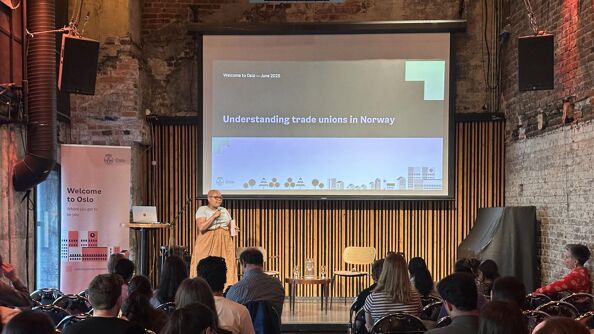 Woman on stage in front of a crowd