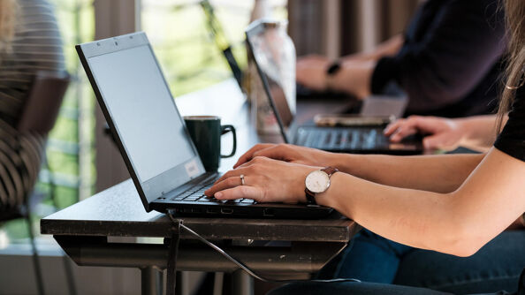 People taking notes on laptop