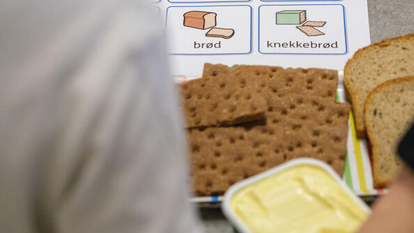Child pointing at food on paper